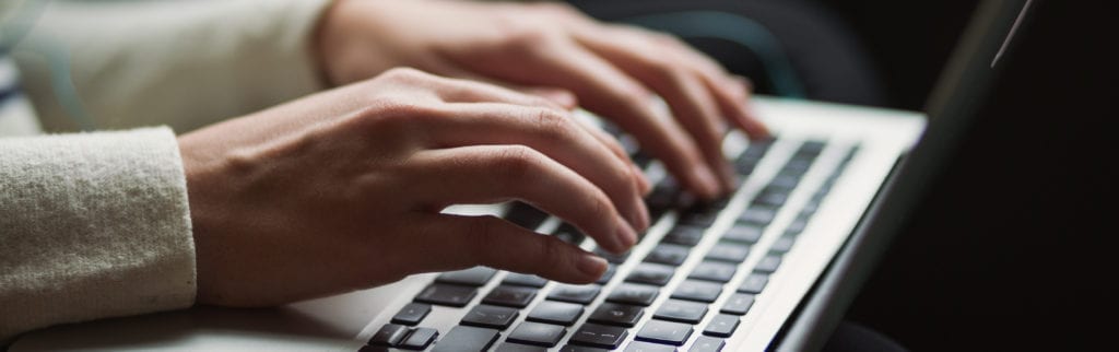 hands typing on a keyboard