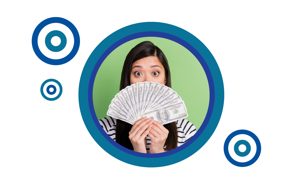 Woman holding a fan of cash over her face