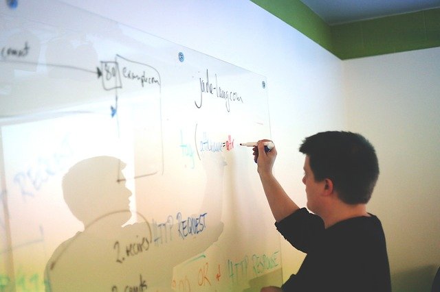 Man writing on white board