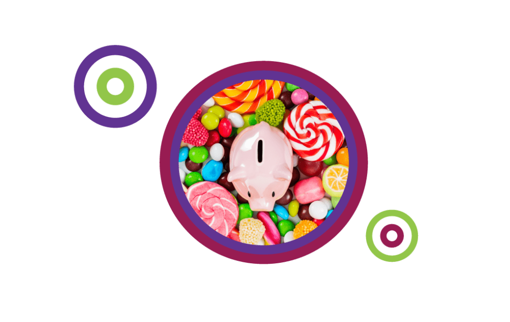 Photo of a piggy bank amidst a large pile of a variety of sweet candy pieces