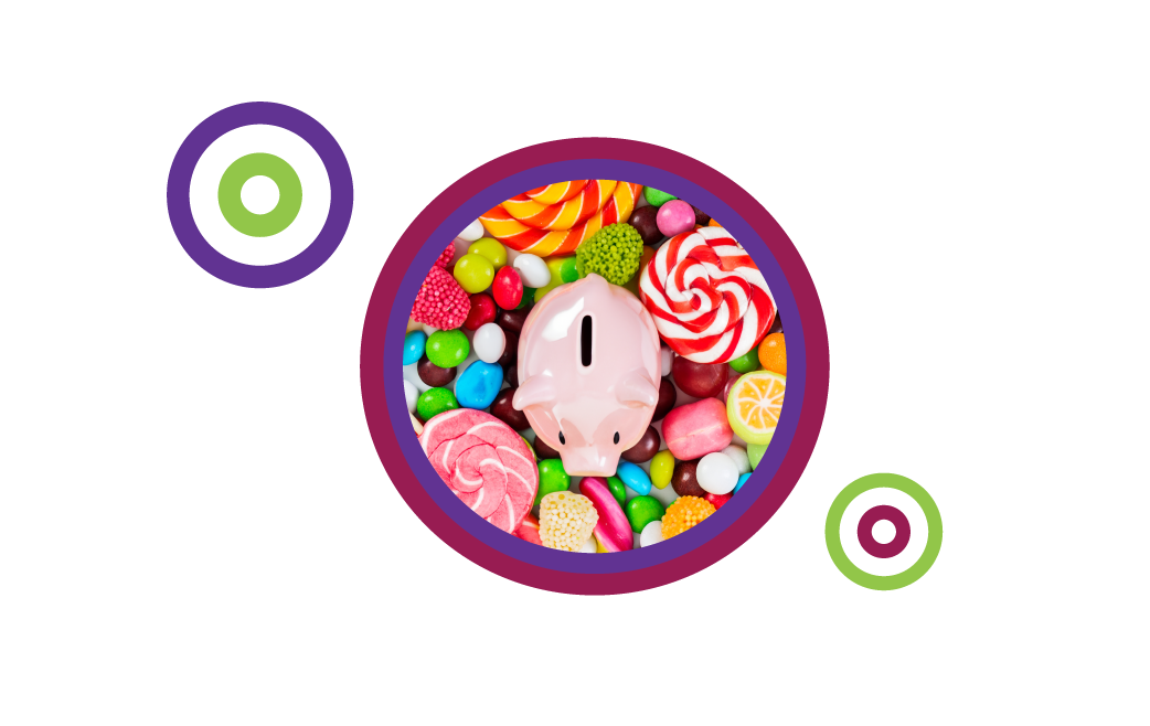 piggy bank amidst a large pile of a variety of sweet candy pieces