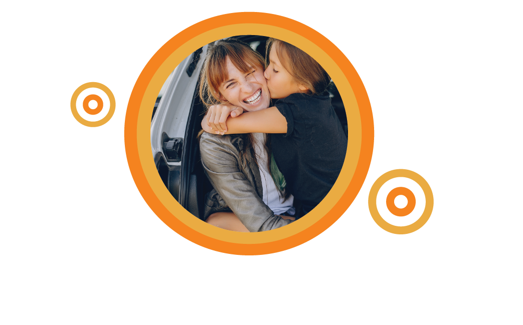 Mother and daughter embracing in the back of a car